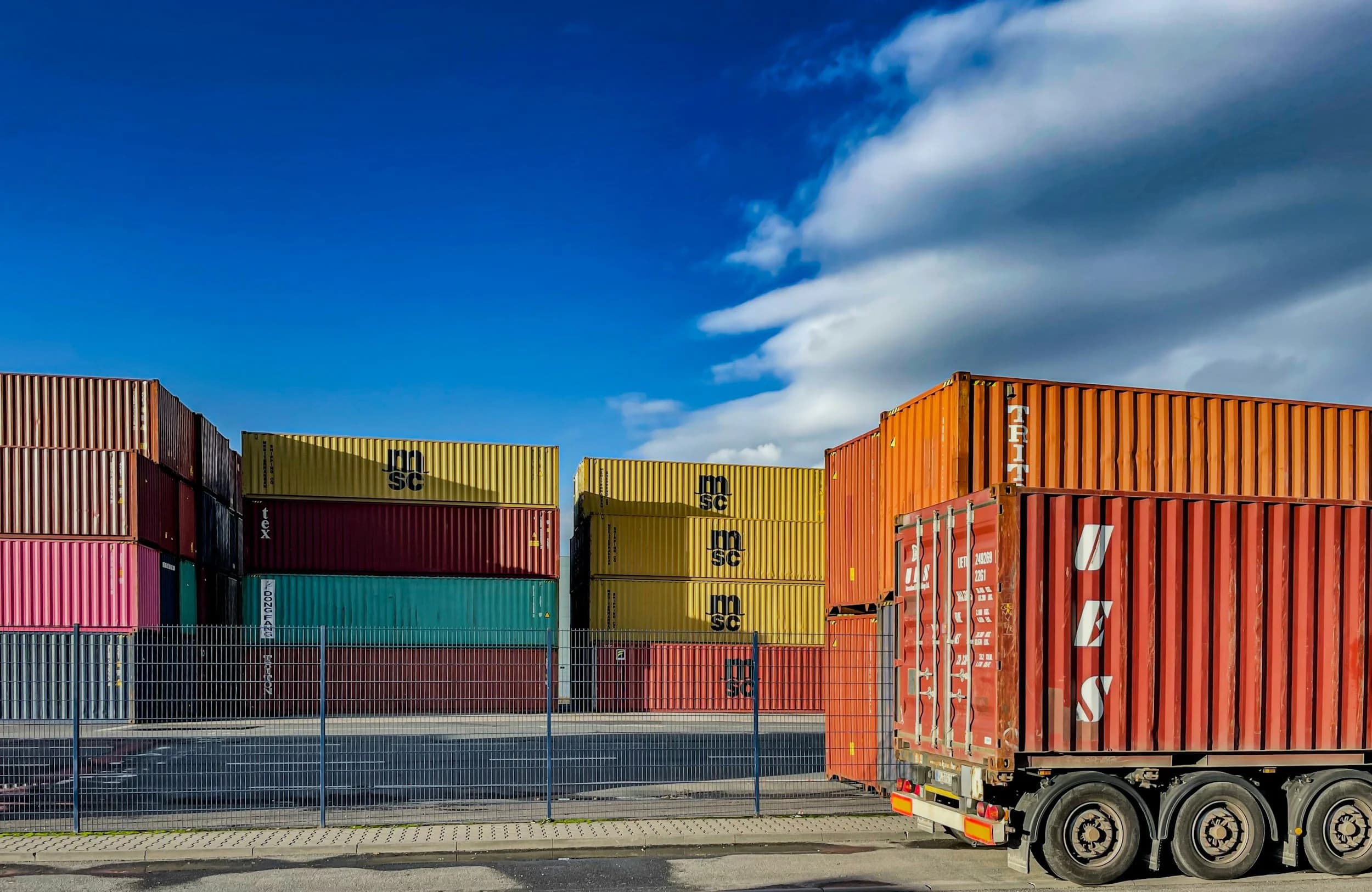 Shipping containers stacked at a commercial freight hub
